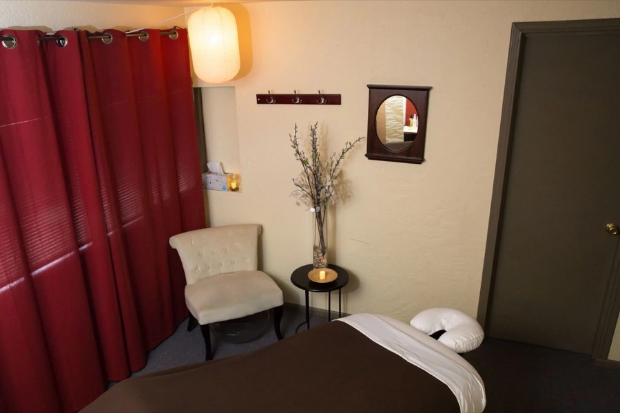 Massage treatment room with soft lighting and warm tones